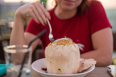 Midsection of woman holding ice cream