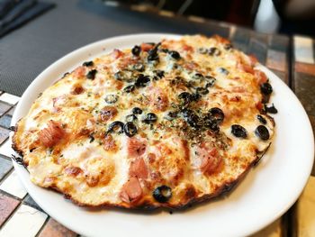 High angle view of pizza in plate on table