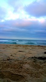 Scenic view of sea against cloudy sky