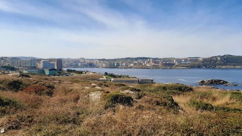 Scenic view of sea and buildings against sky