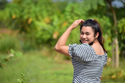 Portrait of smiling young woman standing outdoors