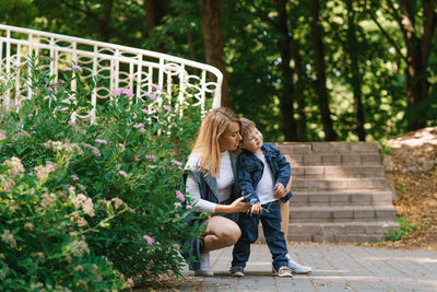 Family weekend in summer in the park for a walk. the three-year-old son is tired of walking