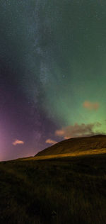 Scenic view of field against sky at night