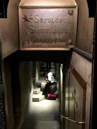 Woman with text on entrance of building