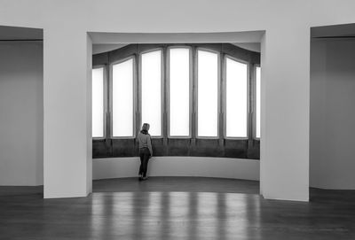 Rear view of woman standing in corridor