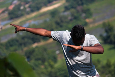 Man gesturing while standing outdoors