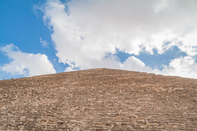 Low angle view of arid landscape against sky