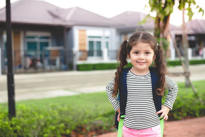 Portrait of smiling girl standing outdoors