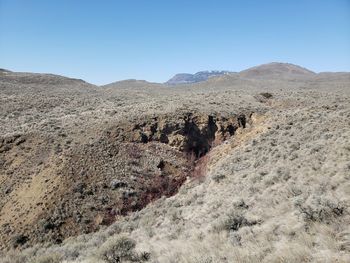 Scenic view of arid landscape against clear sky