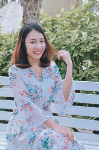 Portrait of a smiling young woman standing outdoors