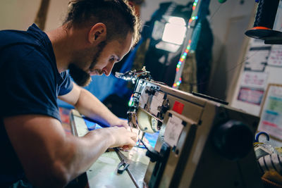 Man working on sewing machine