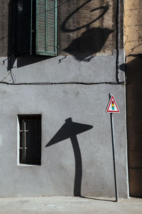 Road sign on street against building