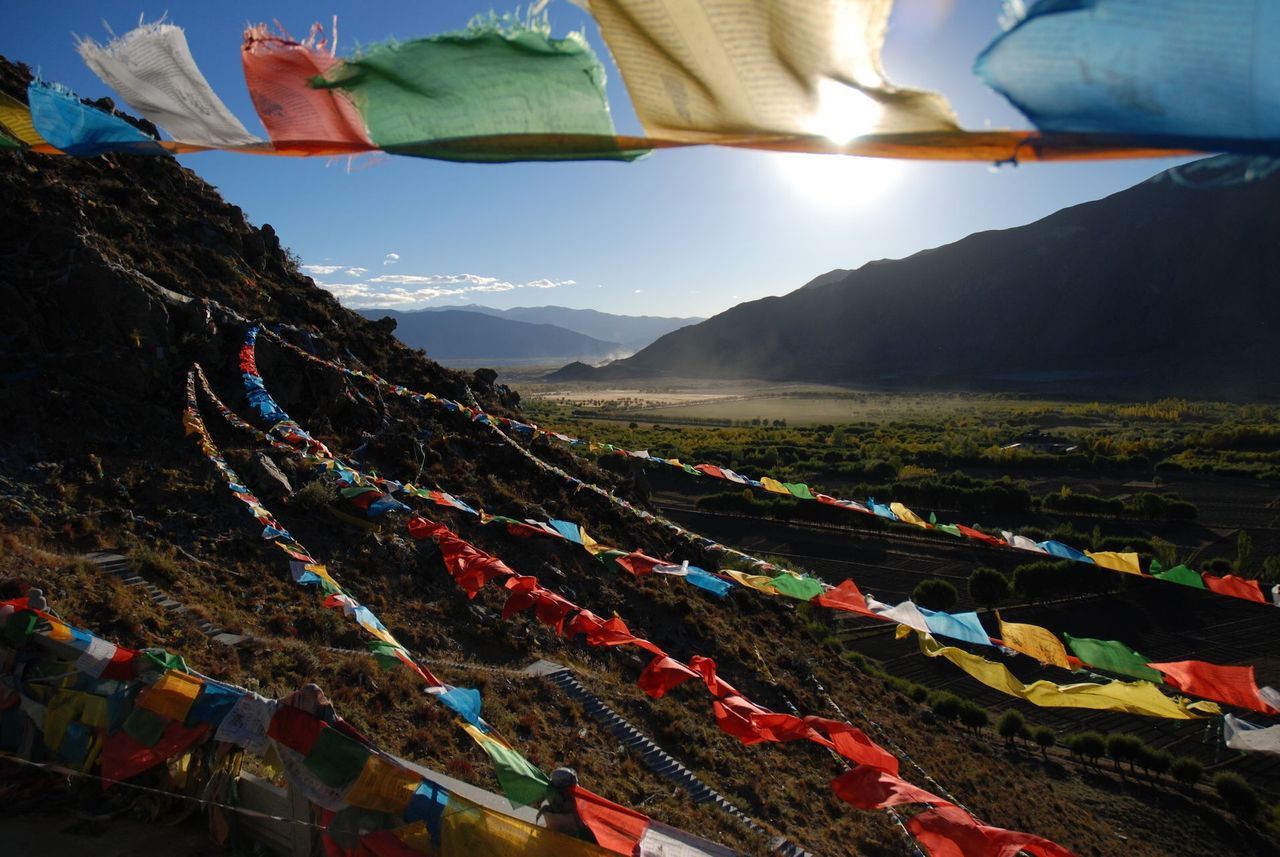 mountain, sky, multi colored, mountain range, landscape, transportation, large group of people, mode of transport, tent, travel, outdoors, day, scenics, nature, tranquility, vacations, in a row, beauty in nature, panoramic, red