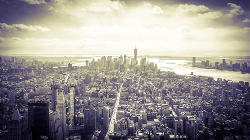 View of cityscape against cloudy sky