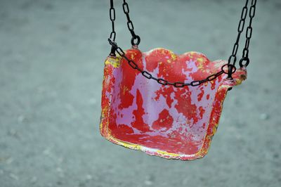 Close-up of old swing at park