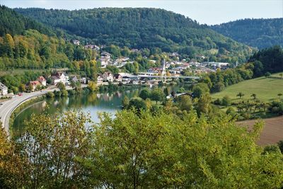 High angle view of trees and buildings against mountains