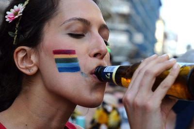 Close-up portrait of man holding beer bottle