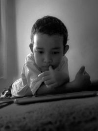 Portrait of cute boy sitting at home