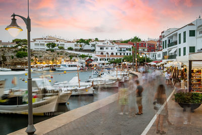 Menorca spain  august people in the es castell harbor at sunset touristic town 