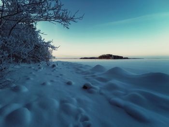 Scenic view of frozen lake against clear sky during winter