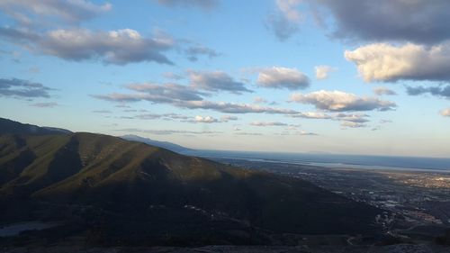 Scenic view of mountains against cloudy sky