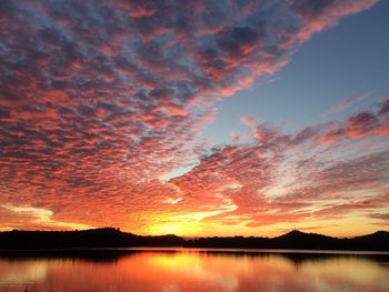 Scenic view of lake against romantic sky at sunset