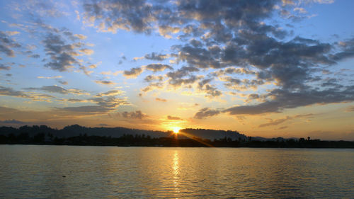 Scenic view of lake against sky during sunset