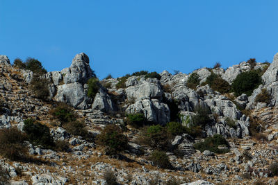 Scenic view of rocky mountains against clear blue sky