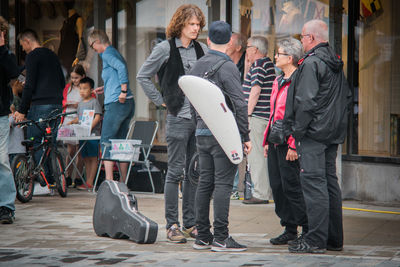 People standing on sidewalk in city