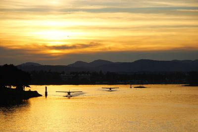 Scenic view of lake against orange sky