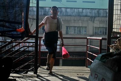 Full length of woman standing by railing