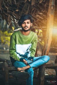 Portrait of young man sitting on chair