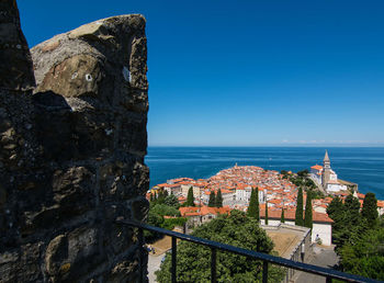 High angle view of buildings against blue sky