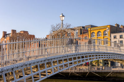 Bridge in city against clear sky