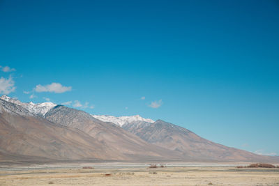 Scenic view of mountain against blue sky