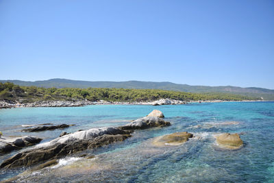 Scenic view of sea against clear blue sky