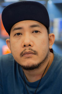 Close-up portrait of man wearing cap outdoors