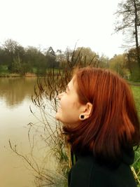 Portrait of woman in lake against sky