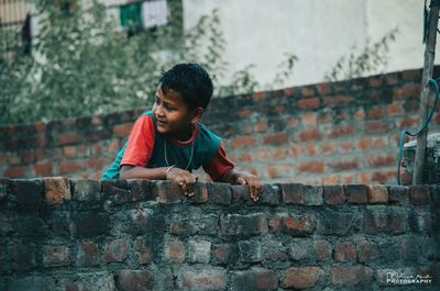 Full length of boy playing on wall