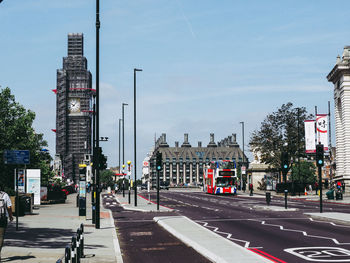 View of city street and buildings against sky