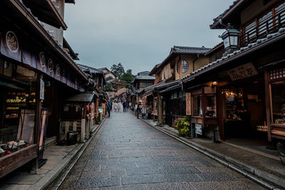 Street amidst buildings in city against sky