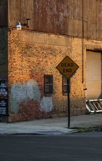 Road sign against built structure