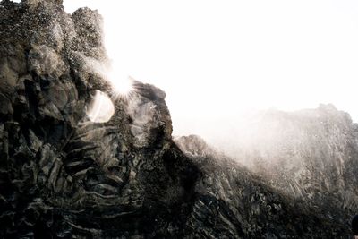 Low angle view of rock formation against sky