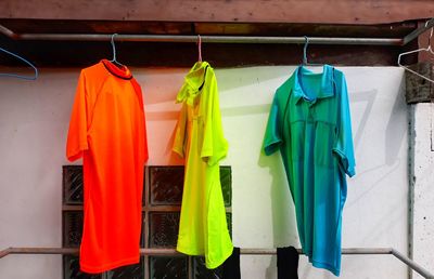 Close-up of clothes drying on clothesline against wall