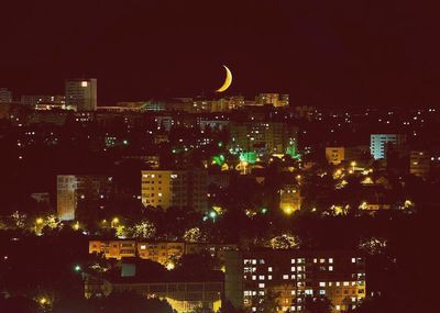High angle view of city lit up at night