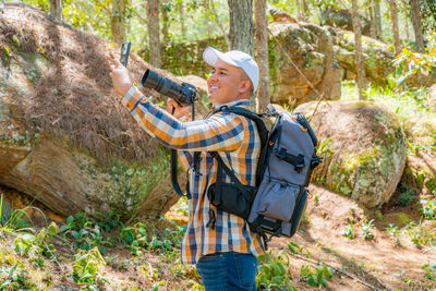 Rear view of man standing on rock