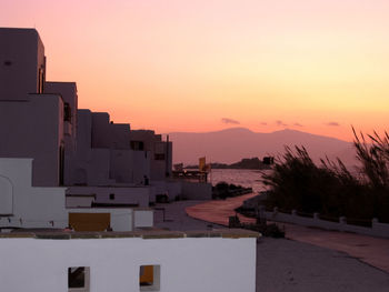 Buildings against sky during sunset