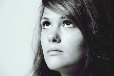 Close-up portrait of beautiful young woman over white background