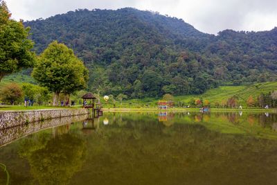 Scenic view of lake and mountains against sky