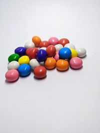 Close-up of multi colored balls on white background
